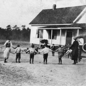 old photograph - children playing outside - schoolhouse