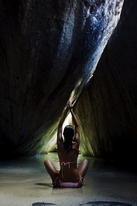 woman practicing yoga in a cave (by fineartamerica)