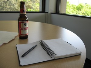 Beer bottle and writing notebook (Flickr by WadeRockett)