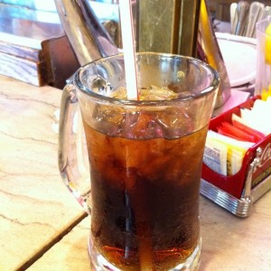 glass of soda and ice (flickr by latca)