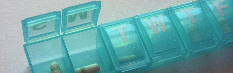 Daily medication dispenser with pills