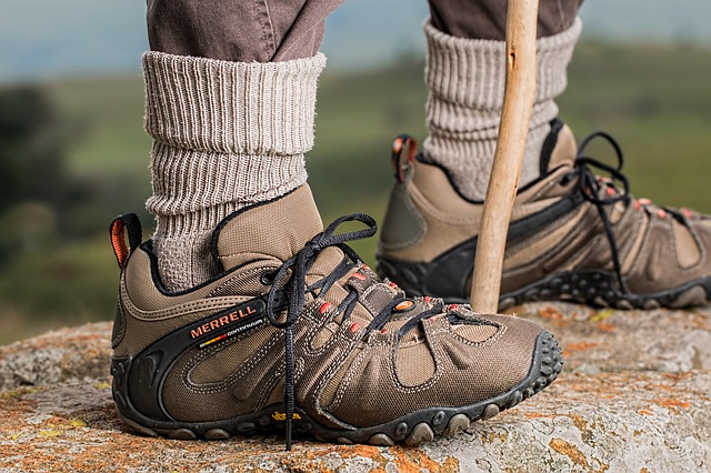 Close-up shot of a man wearing hiking boots outside