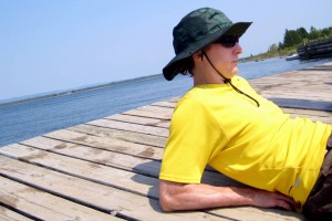 Man relaxing on a pier on Manitoulin Island, Ontario (by Shawn Radcliffe)