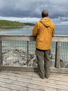 Author moving beyond the trauma vortex as he stands on a lookout on the shoreline of Georgian Bay, part of Lake Huron, Ontario